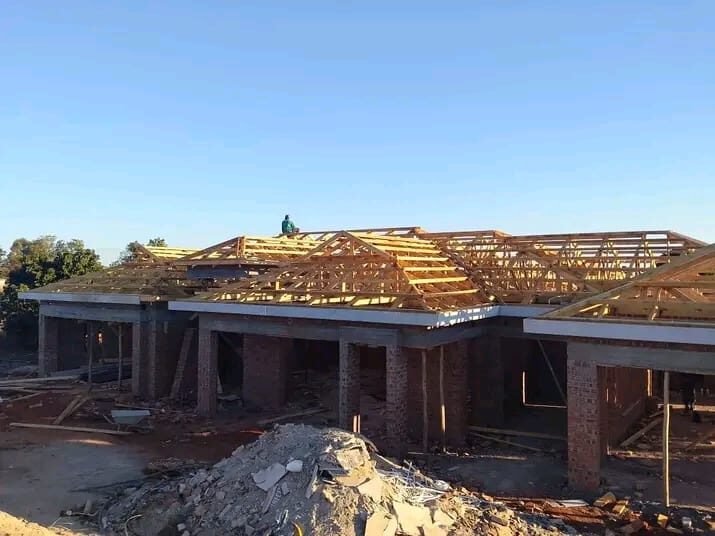 Timber roof trusses on a brick building